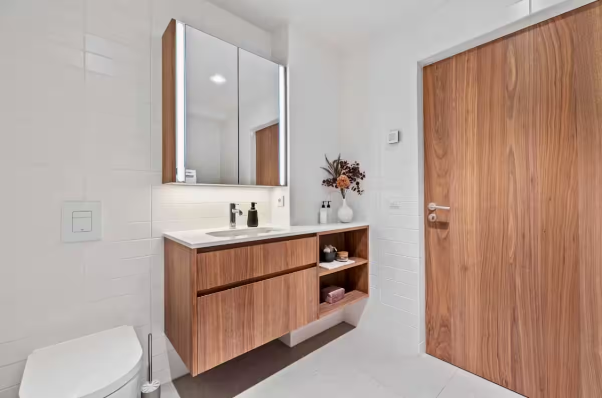 Main bathroom vanity with wood cabinetry