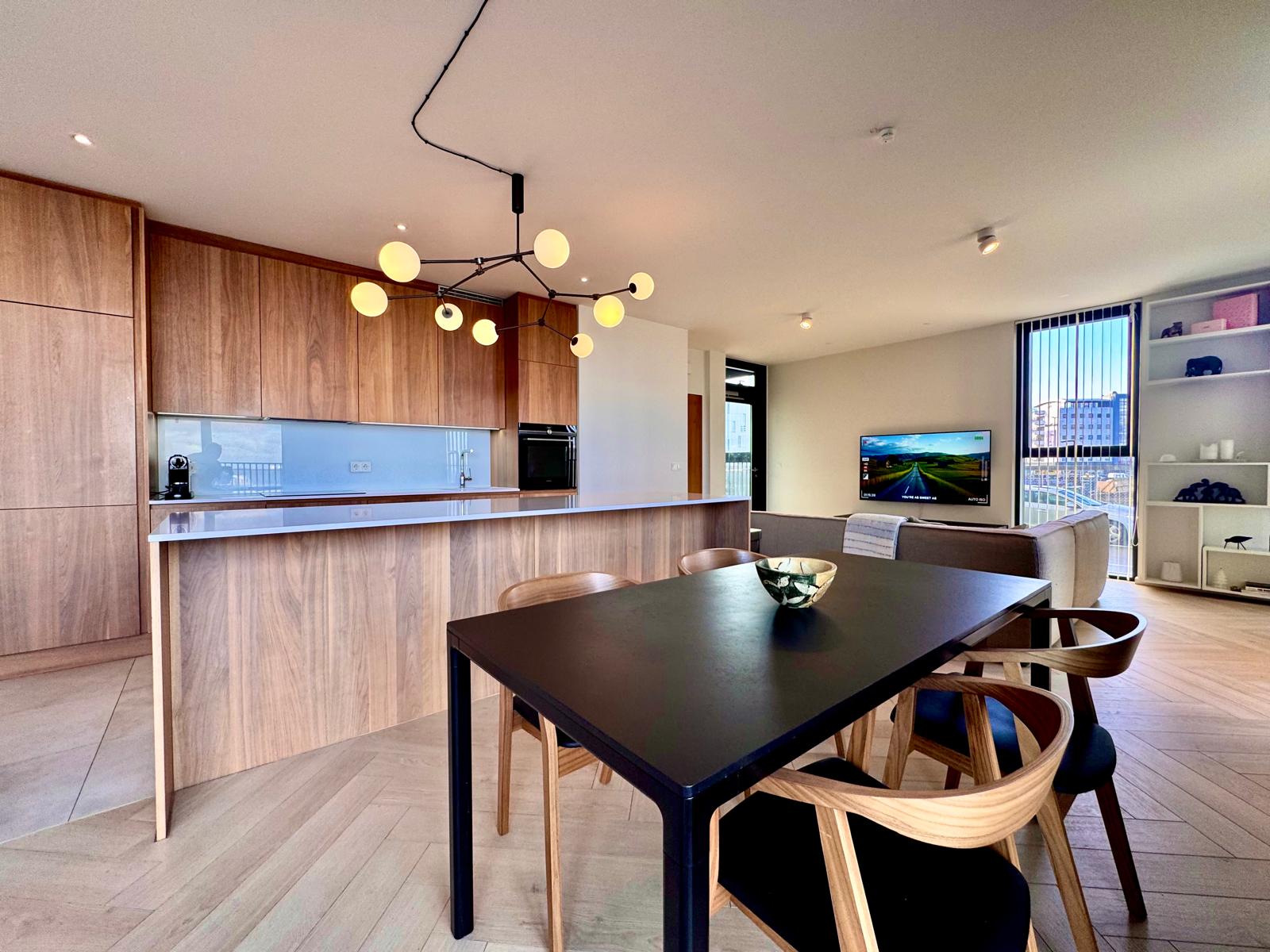 Walnut kitchen with sculptural lighting